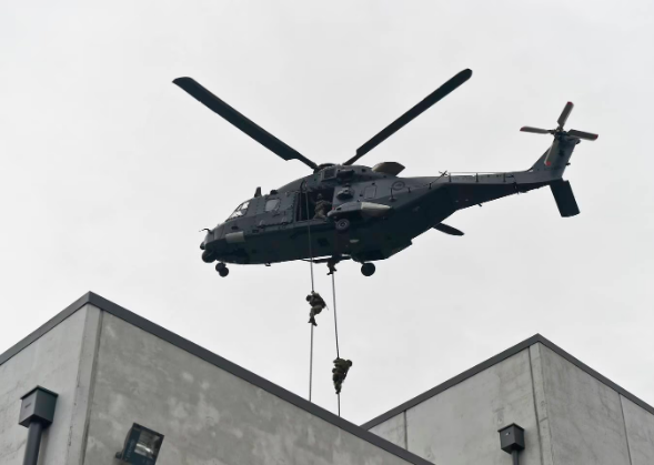 NZSAS troopers fast-roping from an NH90 helicopter to the Method of Entry house at the Ardmore...