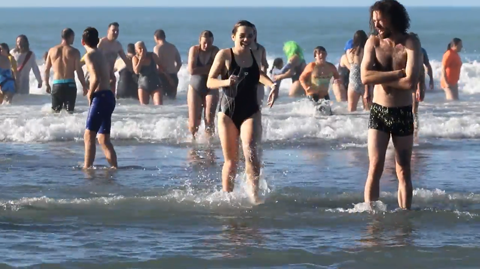 Swimmers head back to the warmth of a towel after their cold plunge at the Waikuku Beach Surf...