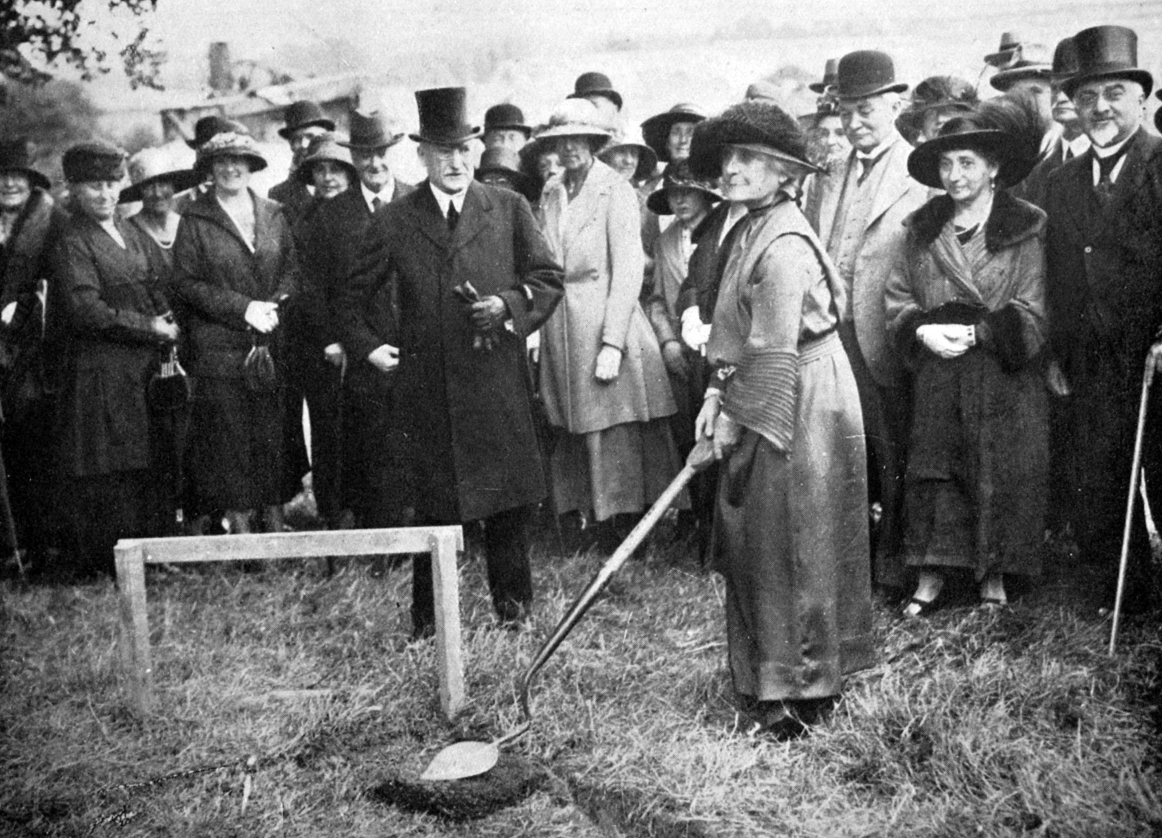 Lady Allen, wife of New Zealand high commissioner Sir James Allen, turns the first sod for a New...