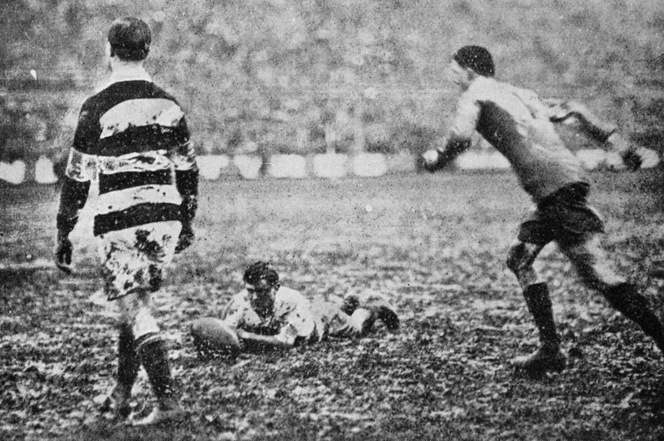 South Island player Steel holds the ball as Sinclair (Otago) aims to convert South's first try in...