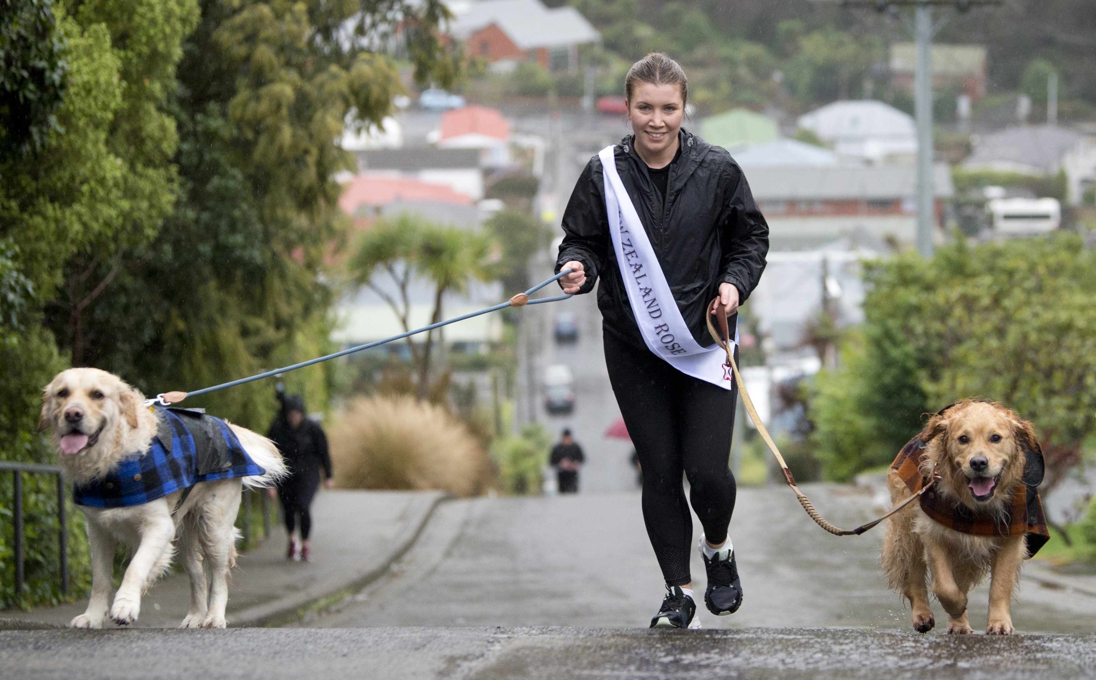 New Zealand Rose of Tralee Kelsi Wallace, accompanied by dogs Teddy (left) and Dug, scale Baldwin...