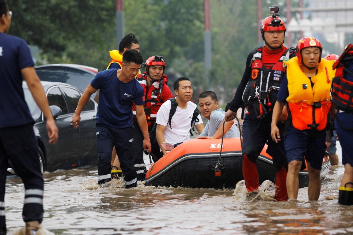 Rescue workers use a boat to evacuate flood-affected residents in Beijing. Photo: Reuters