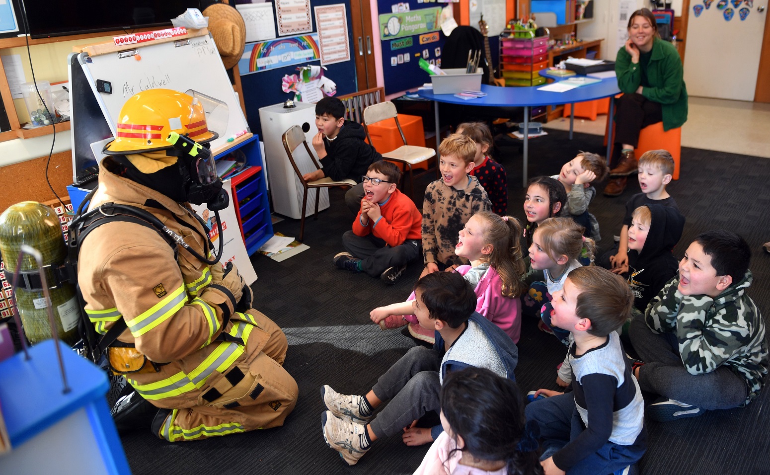 Senior Firefighter Mat Loughney, of Willowbank station, puts on a lesson for a classroom of North...