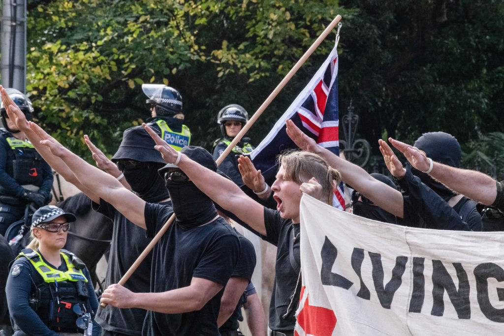 Neo-Nazi protesters salute as they are ordered to leave an anti-immigration rally in Melbourne...