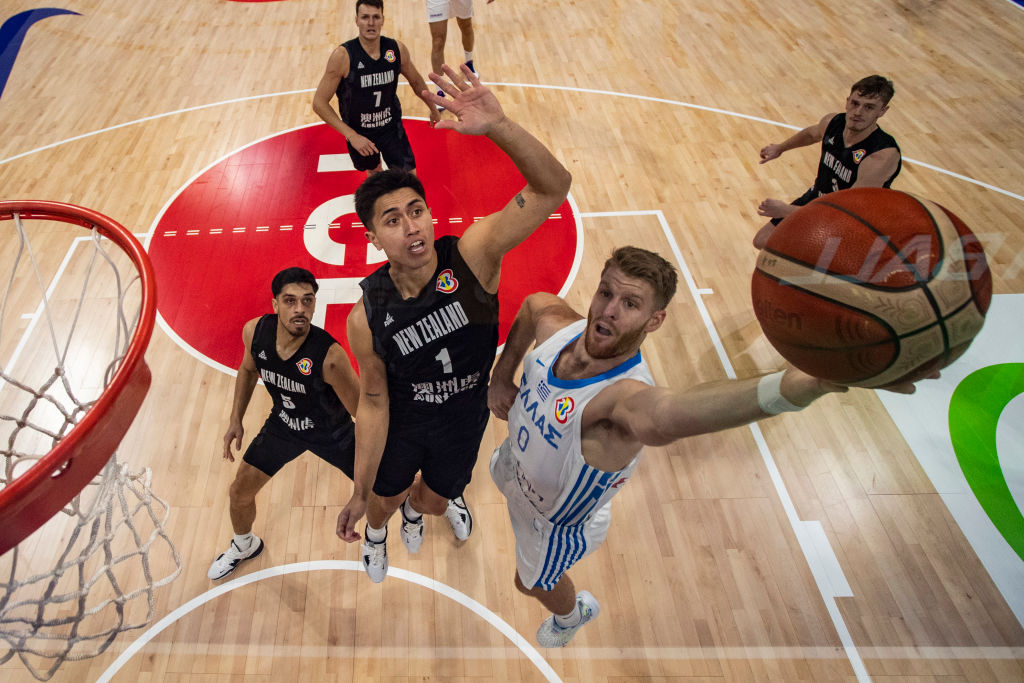 Thomas Walkup of Greece goes for the basket against Tall Black Reuben Te Rangi in Manila. Photo:...