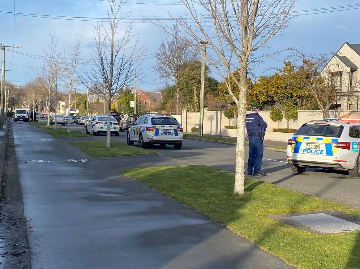 Multiple police vehicles are in the street. Photo: Sam Sherwood