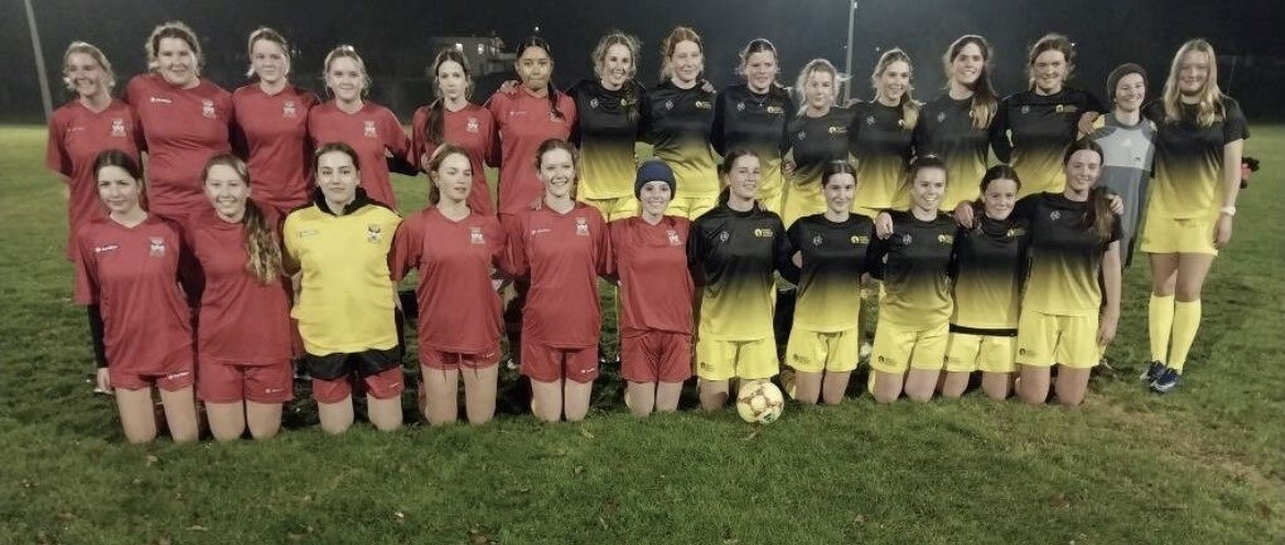 Dunstan and Mount Aspiring girls footballers gather after a recent game.