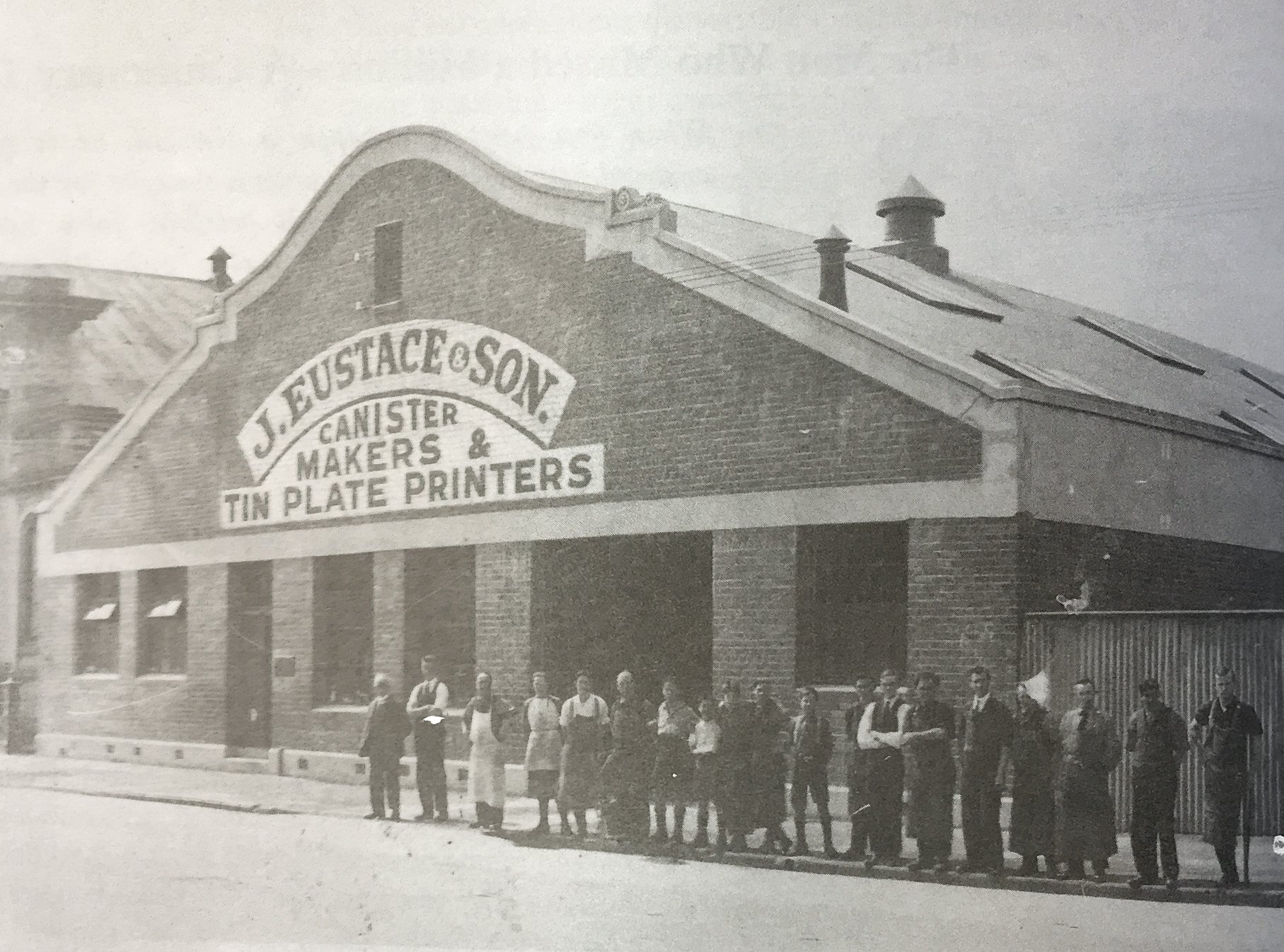 Gathered outside his factory is John Eustace (far left) and his staff some time in the 1920s or...