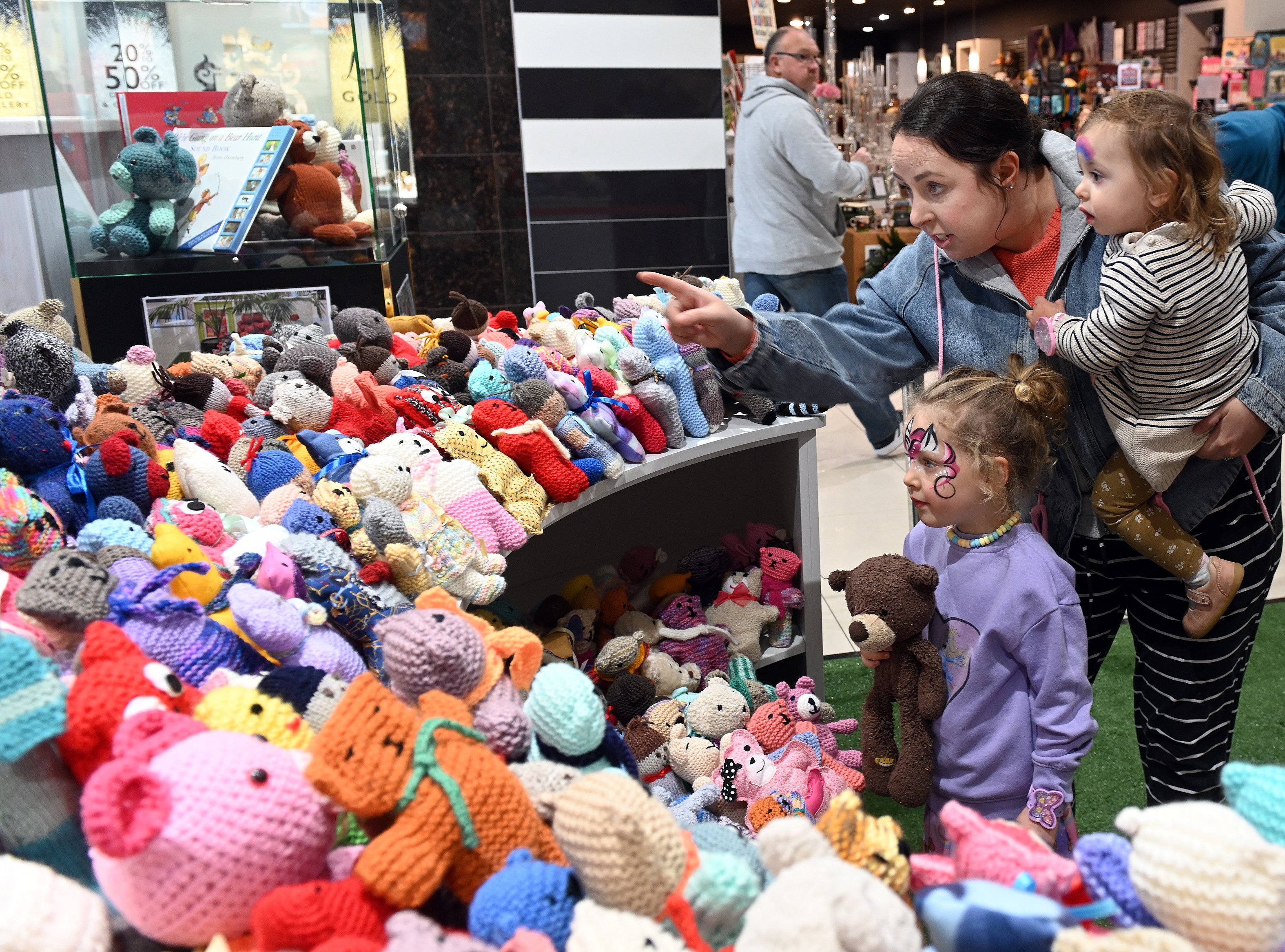 Aila Jones, 4, sister Miya, 1, and mother Jess Jones marvel at the hundreds of tiny teddies on...