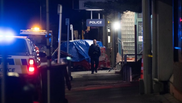 A tarpaulin covers a car after it hit the Timaru Police Station last night. Photo: NZ Herald