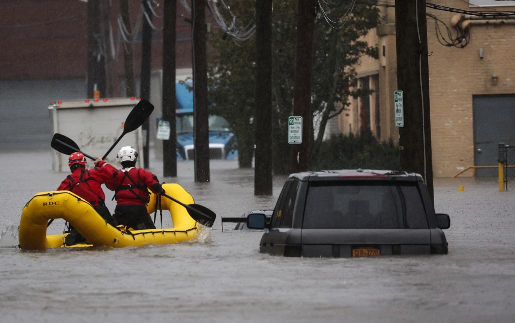 Rescue personnel check buildings for victims trapped in heavy flooding in the New York City...