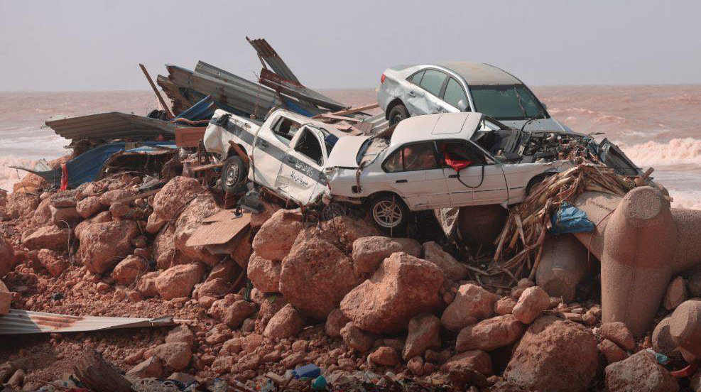 Vehicles and debris were swept toward the coast after a dam collapsed under the strain of heavy...