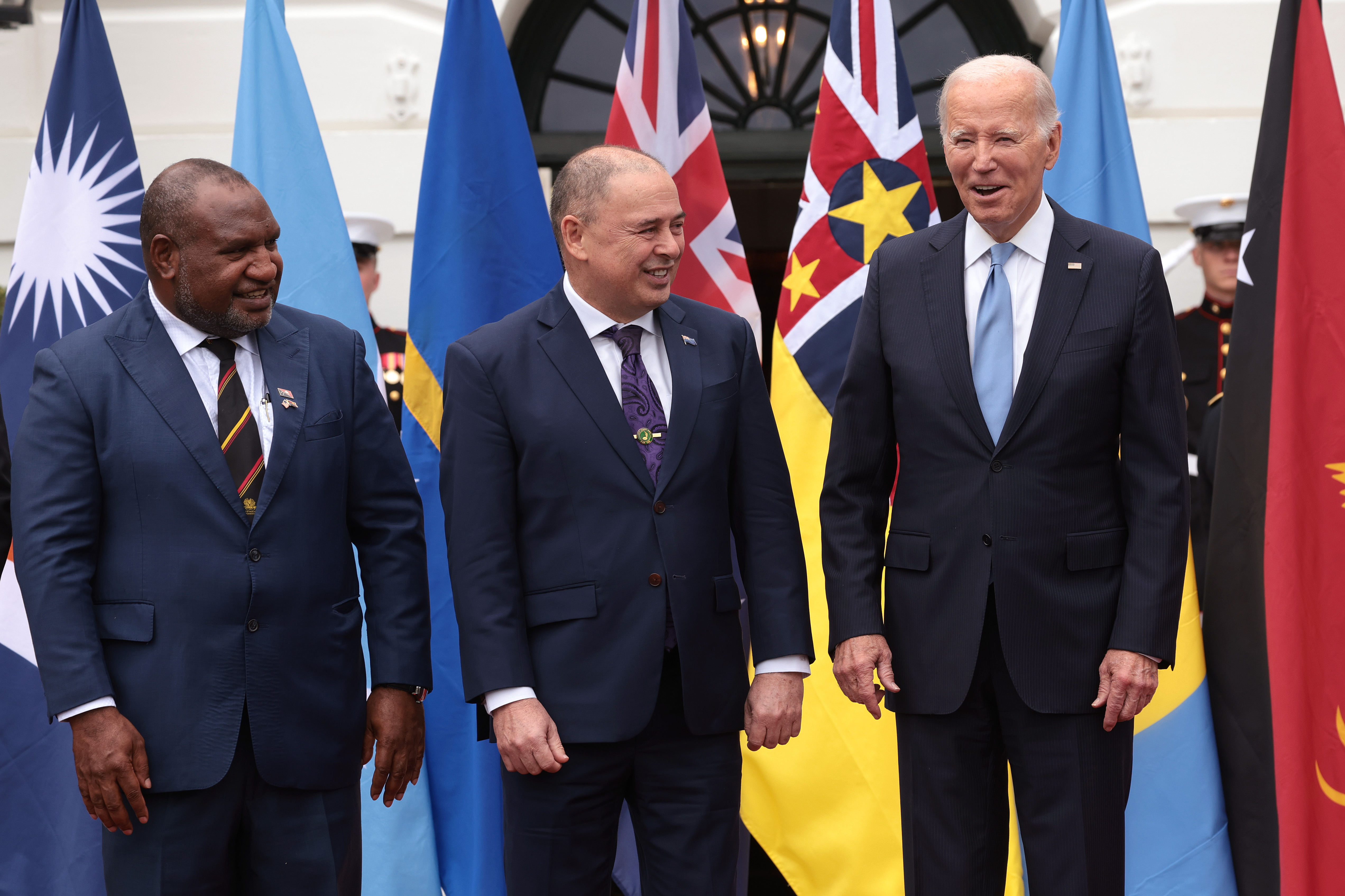 US President Joe Biden (right) stands with Prime Minister of the Cook Islands Mark Brown (centre)...