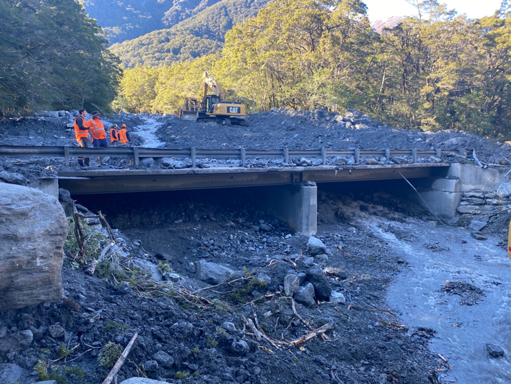 Crews working to remove slip material from the Muddy Creek bridge. Photo: Waka Kotahi