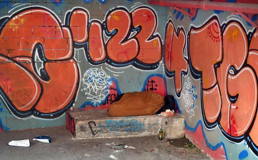 A homeless person sleeps in the open basement below social housing provider Kāinga Ora, in Moray...