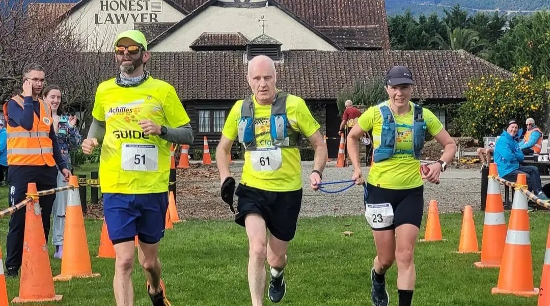 Christchurch-based blind runner Paul Barclay (centre) is flanked by guides Mark Boon (left) and...