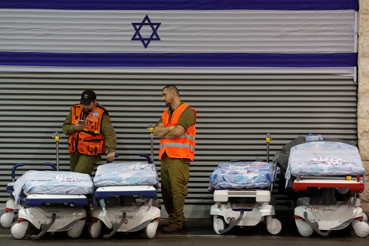 Members of Israel's military Home Front Command wait to assist incoming wounded at the emergency...