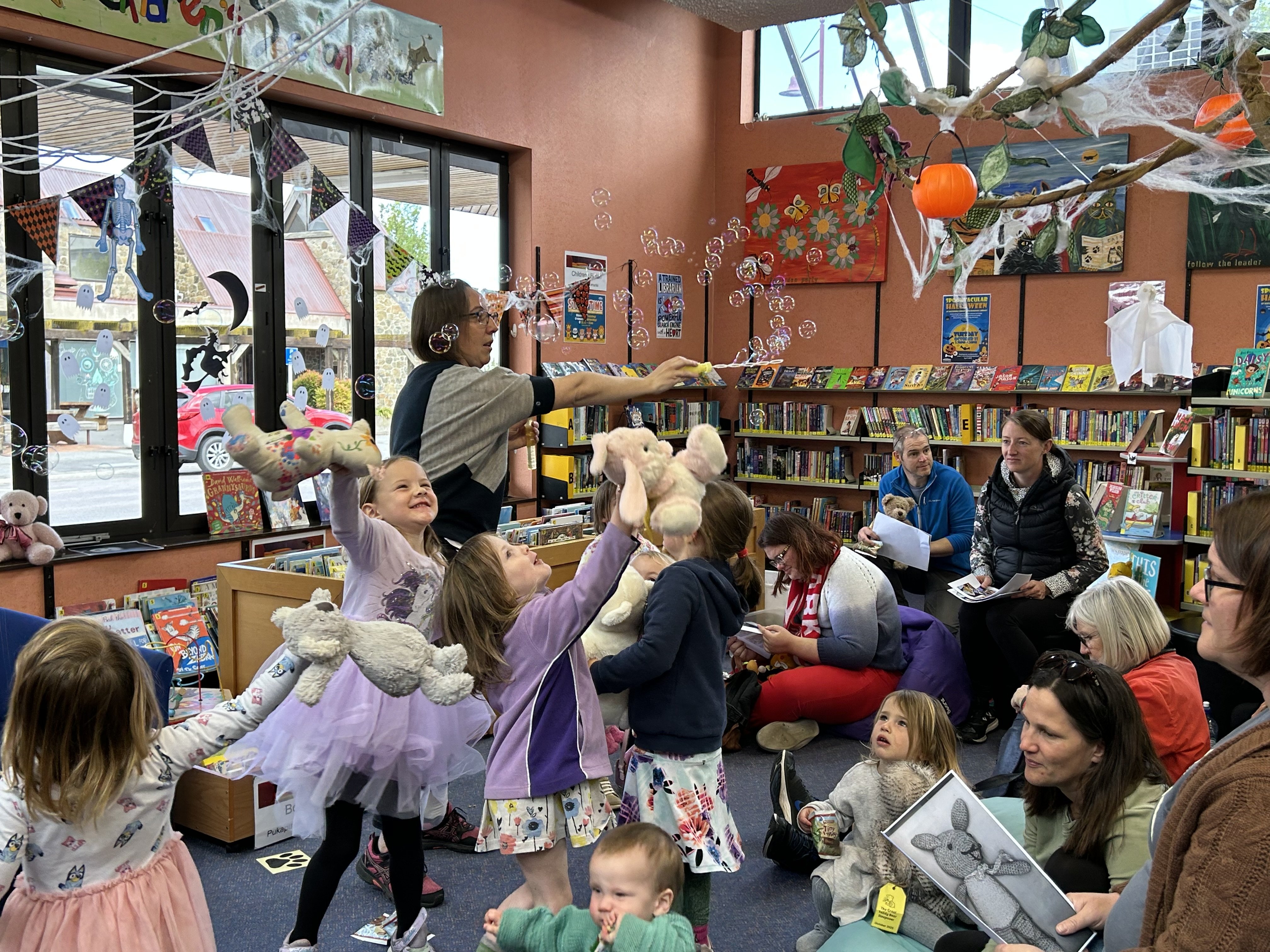 Library assistant Dana Ashby entertains children and their toys at the teddy bears’ picnic in the...