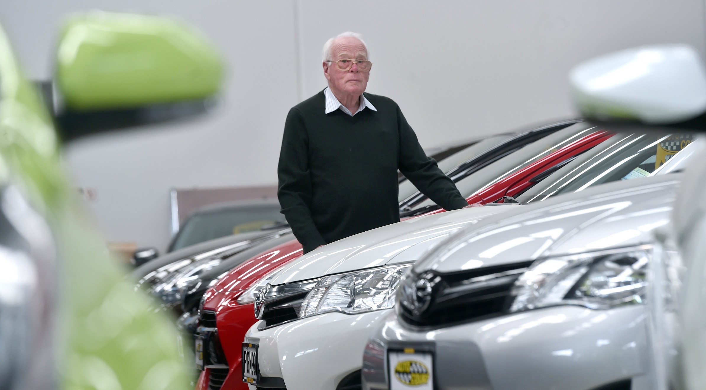 Neil Cottle, of Auto Court, stands amid vehicles eligible for the  clean vehicle discount. Photo:...