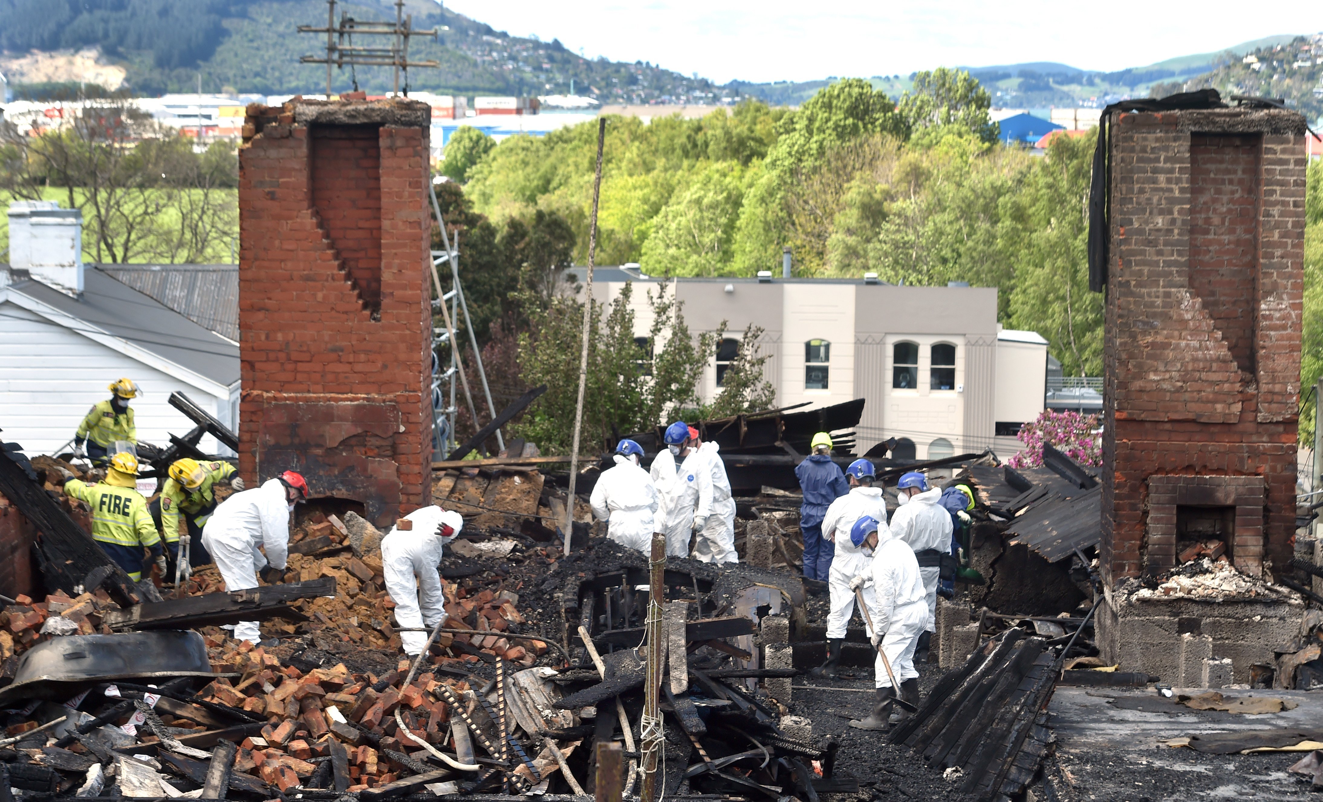 Fire and Emergency New Zealand and police turn over the remains of the former boarding house in...