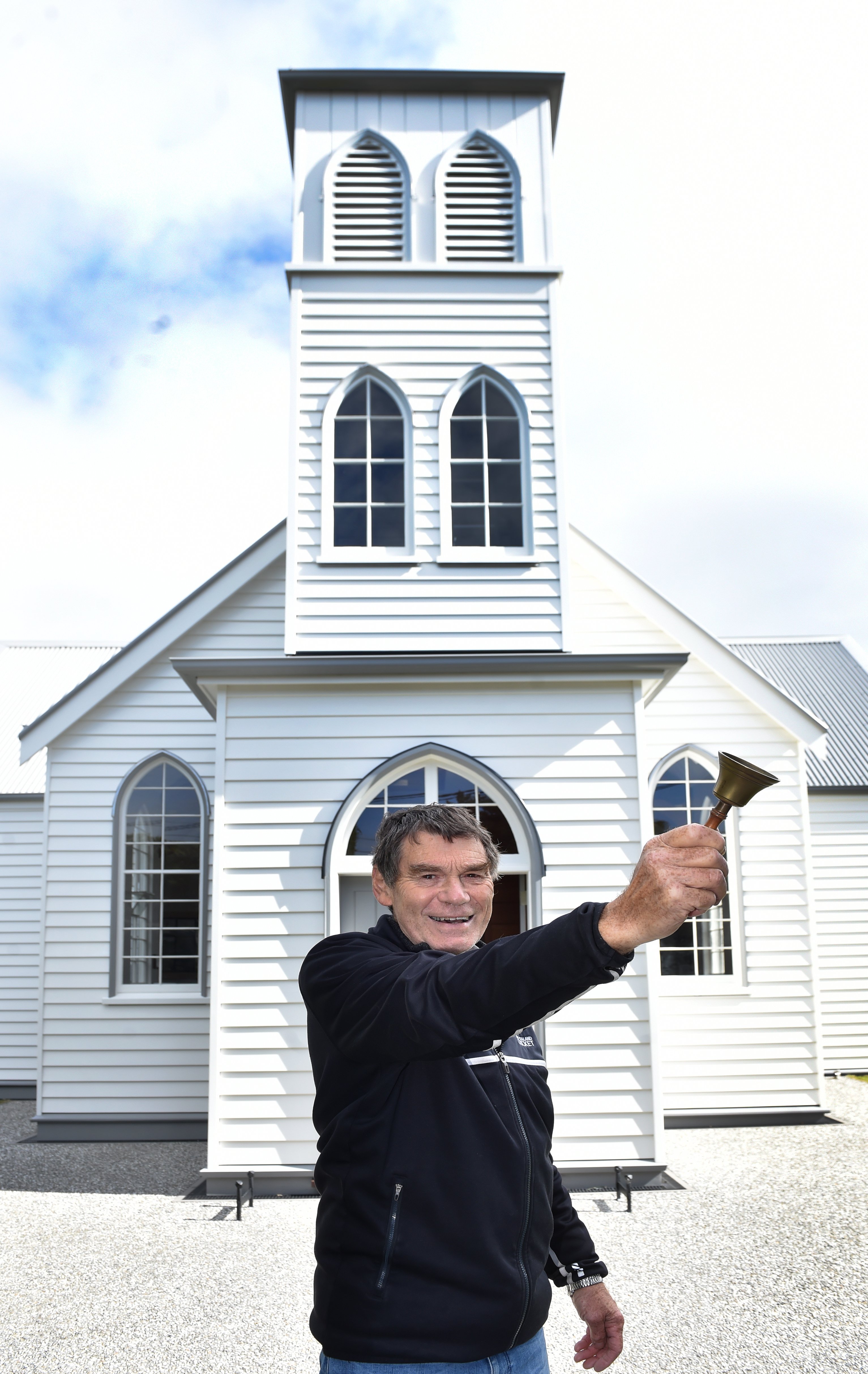 Pukehiki Church Trust member Derrick Railton rings a bell for the community church to mark the...