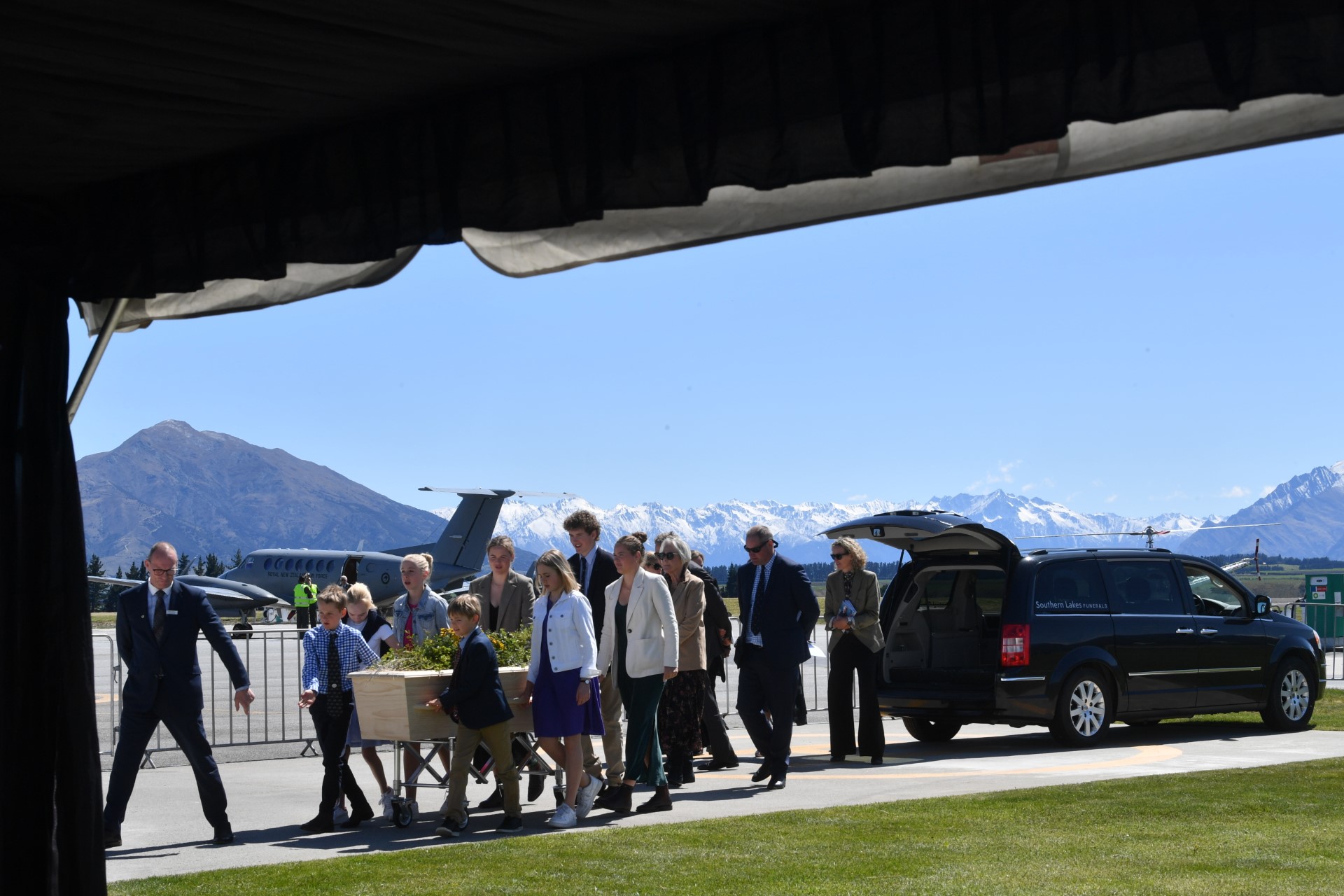Sir Tim Wallis' grandchildren accompanied his casket into the service at Wānaka Airport.  PHOTO...