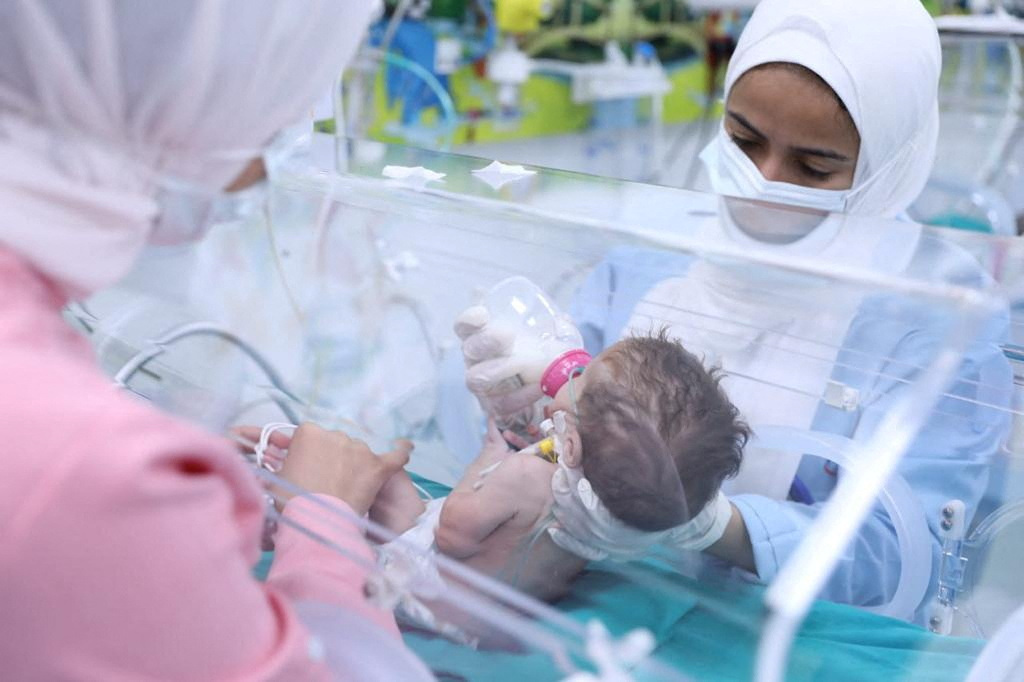 Medics in Egypt's New Administrative Capital near Cairo treat a premature Palestinian baby...