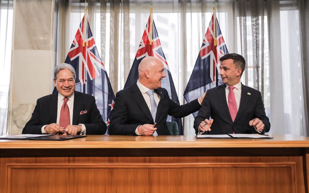 Party leaders (from left) Winston Peters, Christopher Luxon, and David Seymour sign coalition...