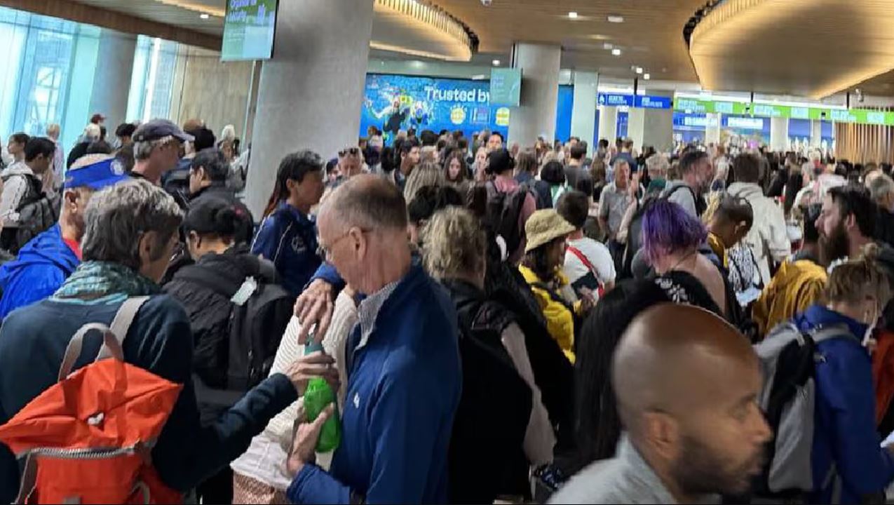 In a photo posted to X, Auckland Airport passengers are seen as they faced long delays in the...