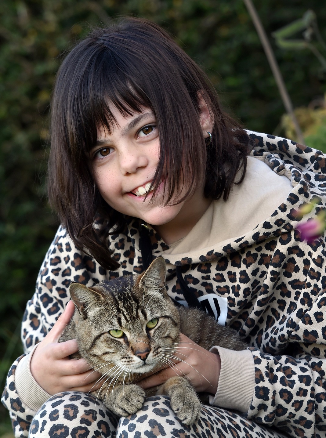 Stella Young, 9, is delighted to be reunited with her cat Neo after he was trapped in the roof...