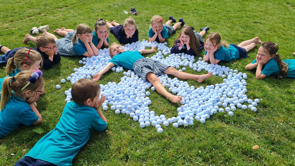 Otatara Schoolchildren bask in all the balls they collected off the green after the Southland...