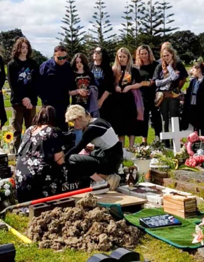 Tania Ranby and her daughter Arnika unveil the combined headstone for their sons/brothers Liam...