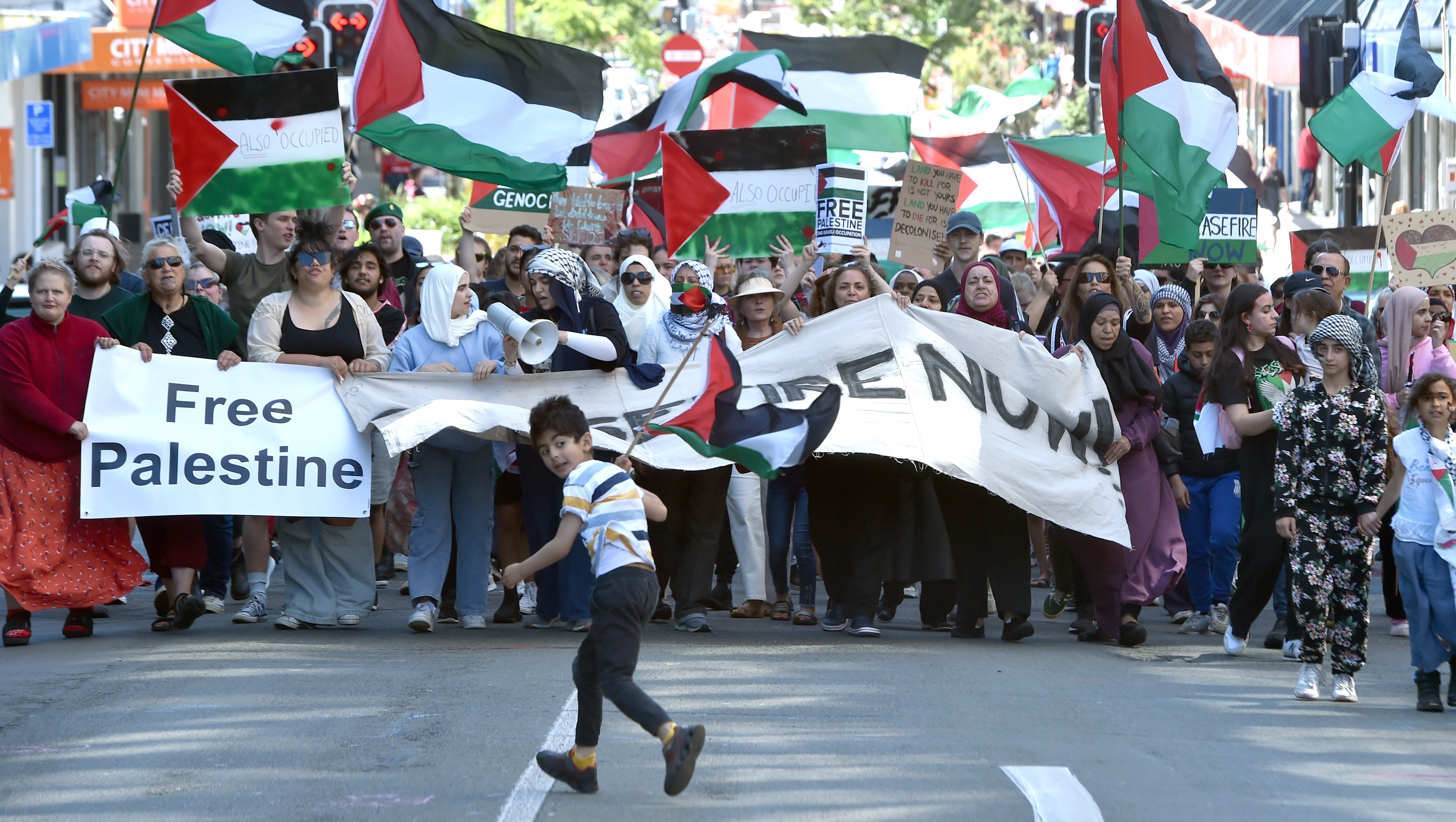 Protesters march in George St, Dunedin, on Saturday, as part of a rally for Palestine. They...