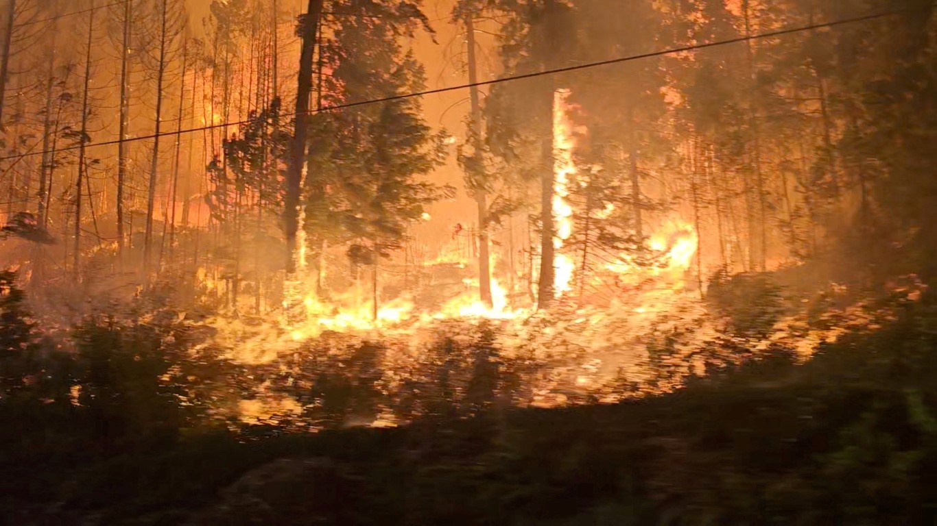 A forest fire burns close to a highway near Sorrento, British Columbia in this screen grab...