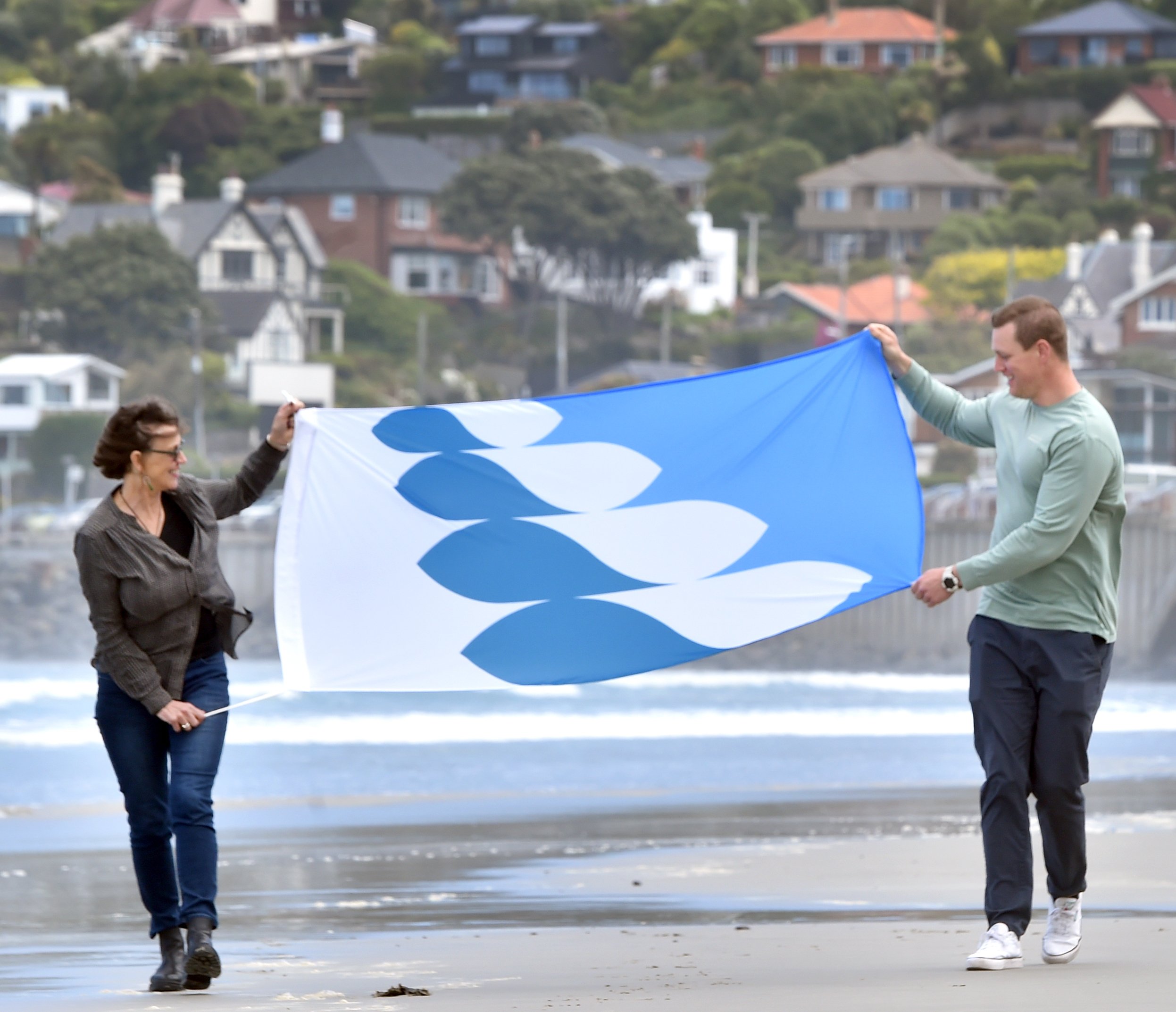 St Clair Esplanade Hydro building trustee Katherine Greer with Jeremiah Hall and his winning flag...