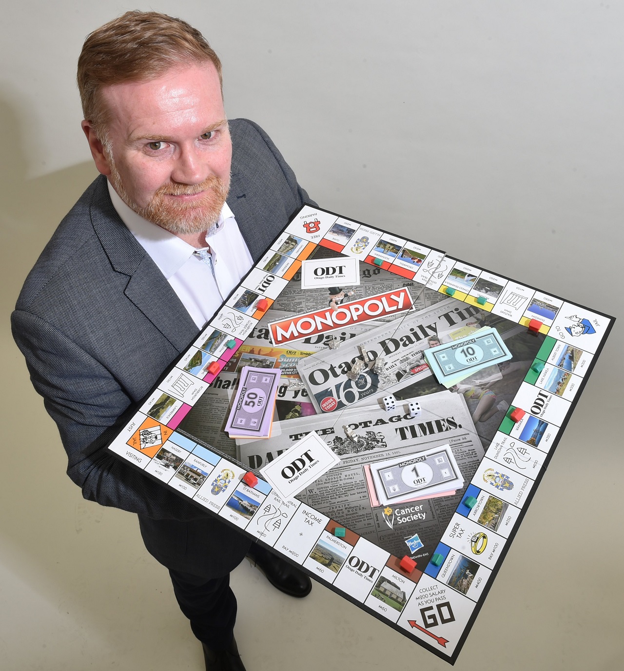 Allied Press commercial manager Matthew Holdridge puts the Otago Daily Times Monopoly game to the...