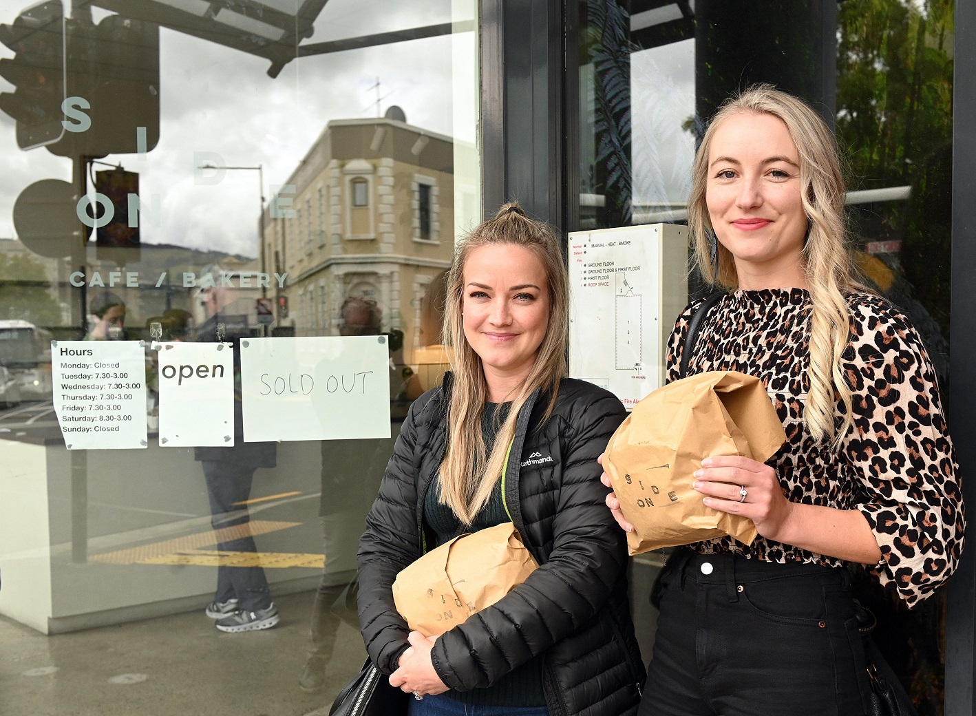 Tamlyn Schafer (left) and Brier Bousie buy some lunch from Side-on Cafe in Moray Pl yesterday,...