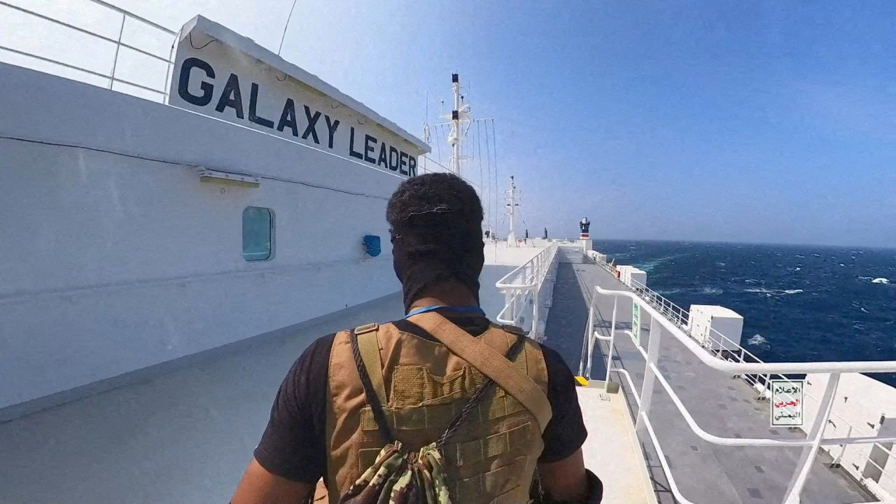 A Houthi fighter stands on a cargo ship in the Red Sea in this photo released on November 20,...