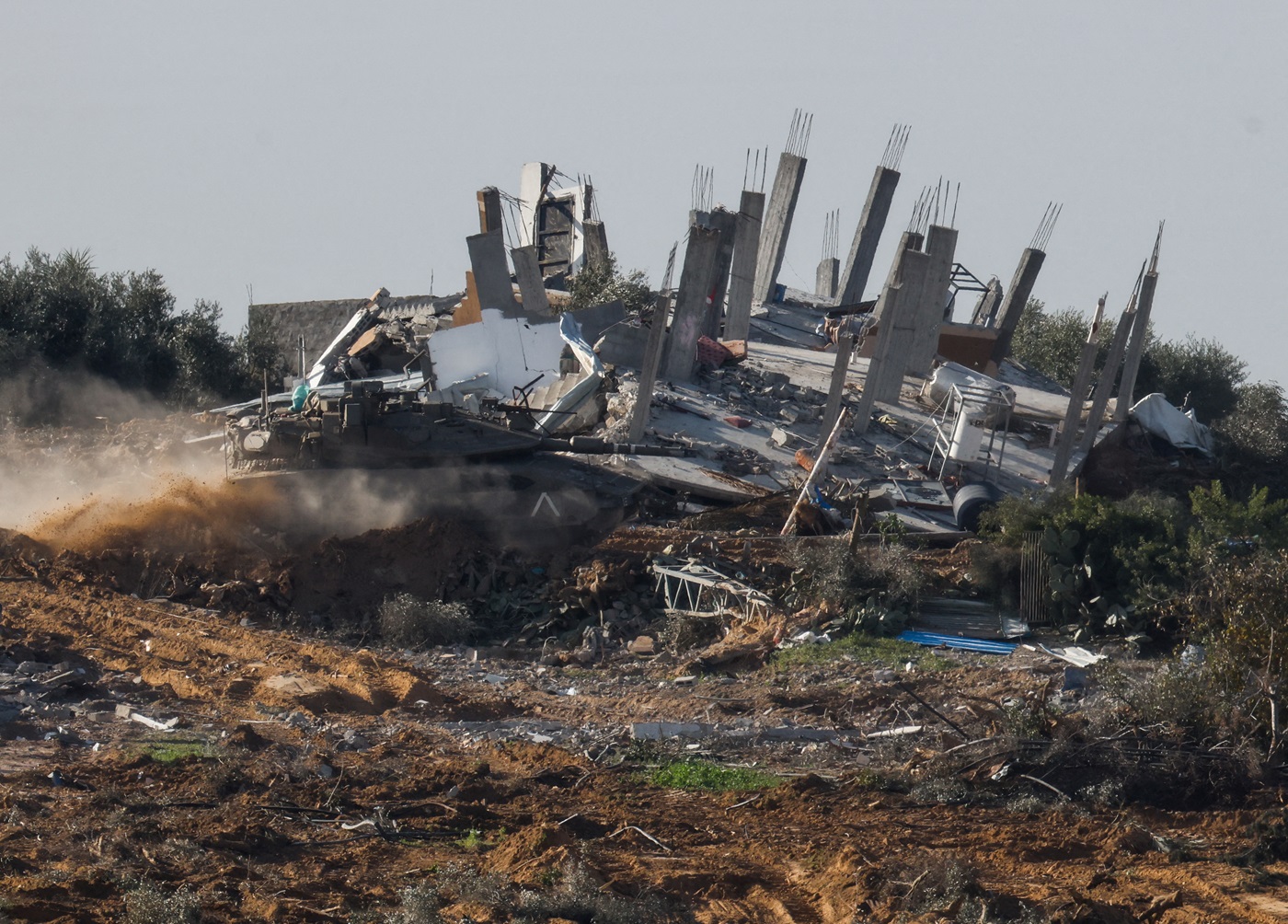 A tank manoeuvres next to a destroyed building in central Gaza. Photo: Reuters