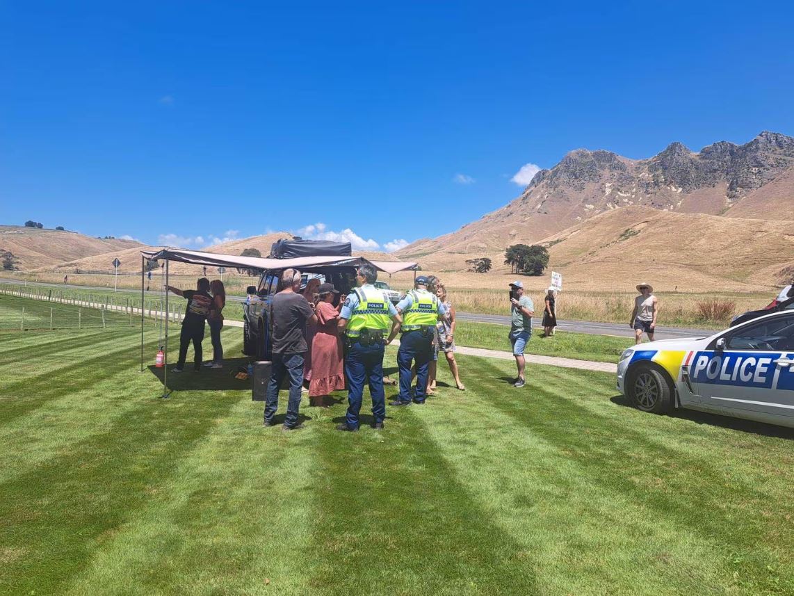 Police talk to protesters outside the Hawke's Bay venue. Photo: Neil Reid