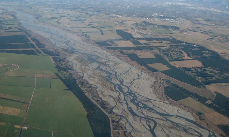 Police say large volume of water is moving through the Waimakariri River carrying logs and debris...