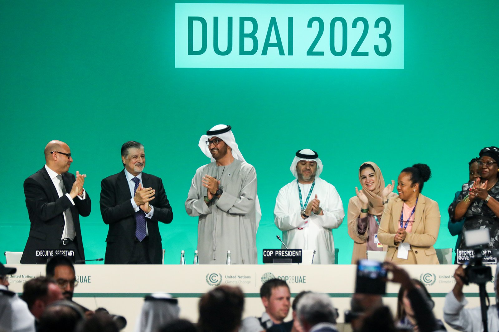 Delegates applaud after a speech by Sultan Ahmed Al Jaber (third from left), President of the...