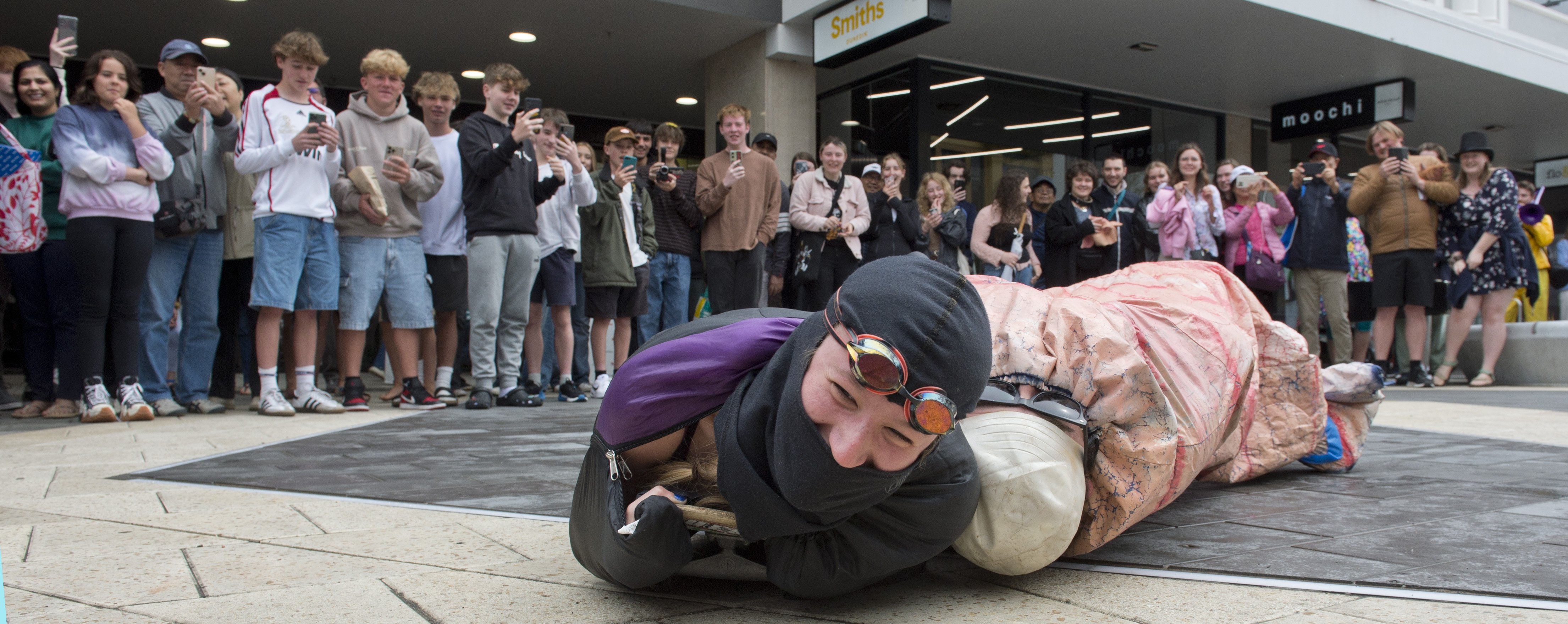 Worm Race competitors Alice Houston-Page (left) and "Cool John" slither up George St towards the...