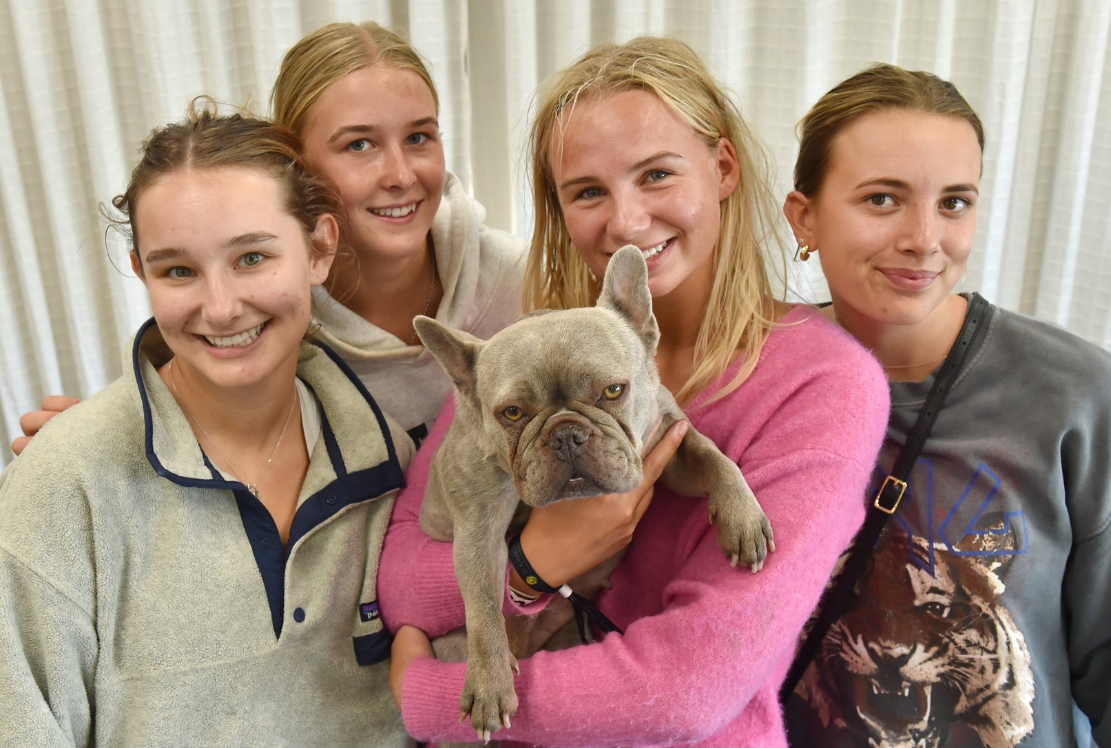Enjoying a hug with Lola are Unicol students (from left) Ruby Young, Greer Tremain, Matilda...