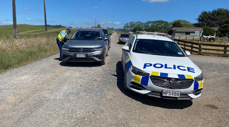 Police turned around traffic after motorists burst through a gate. Photo: NZ Herald 