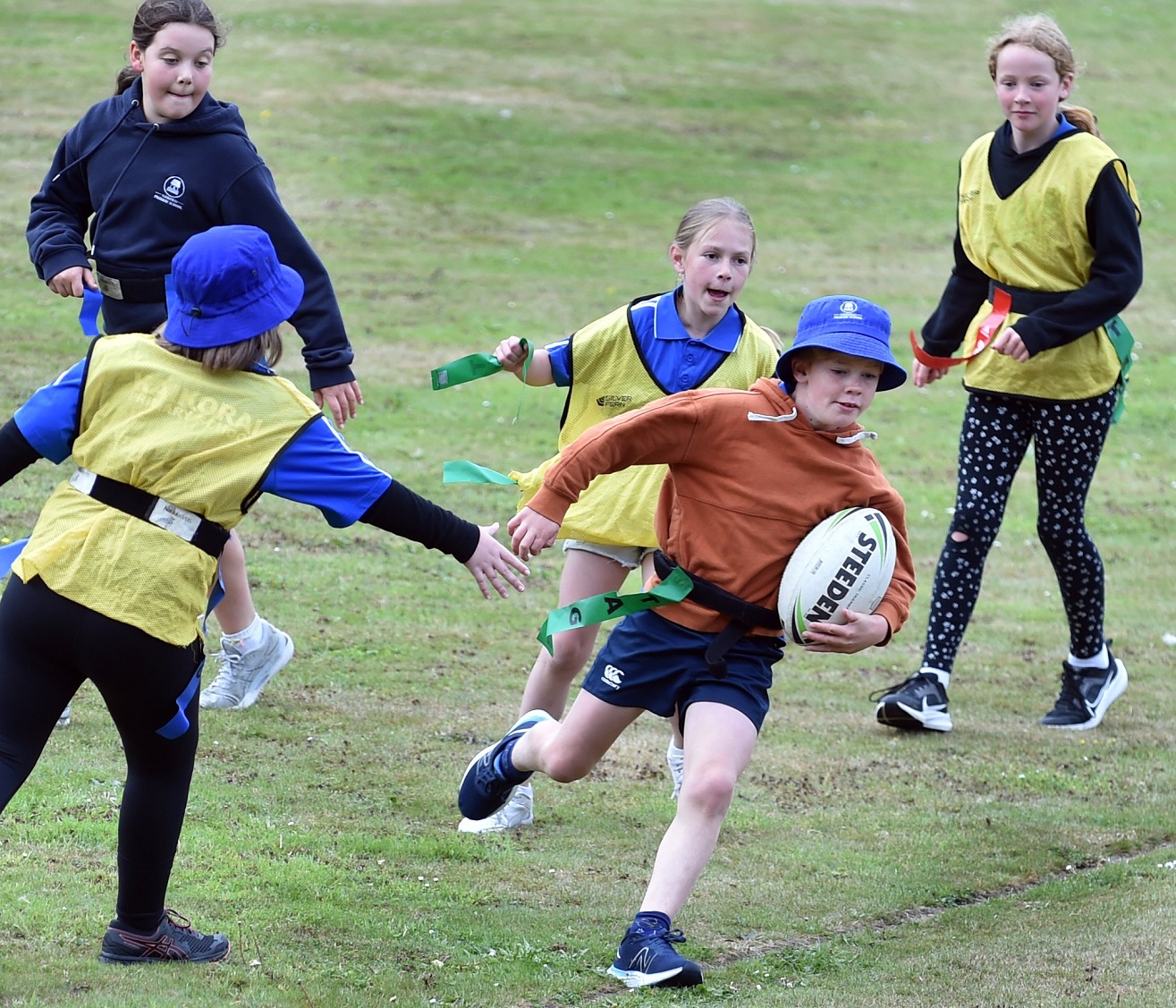 Artie Seymour, 9 ,of Kaikorai Primary School, weaves his way through the opposition.