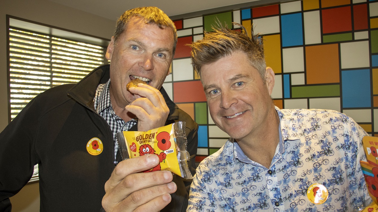 Rangiora RSA Club president Ross Ditmer and Cookie Time general manager Lincoln Booth try one of...