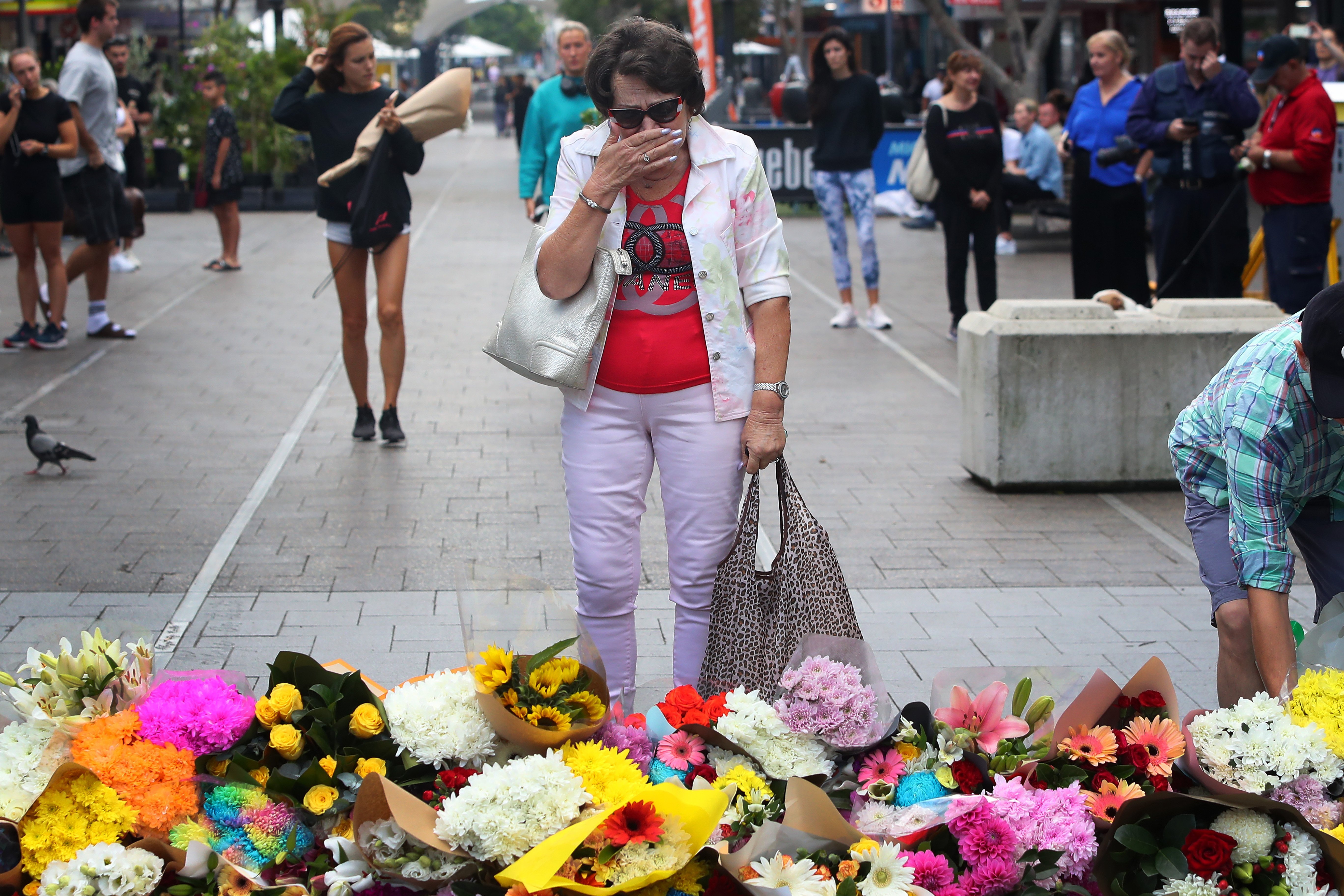 Members of the public lay floral tributes at Oxford Street Mall after six victims, plus the...