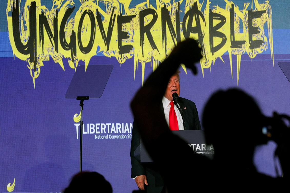 A crowd member gestures as Donald Trump speaks at the Libertarian Party's national convention in...