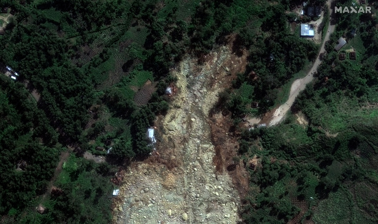 A satellite image shows buried homes after the landslide in Yambali village. Photo: Maxar...